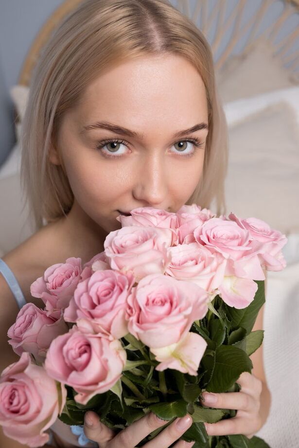 18P Bernie arranges the pink roses on the bed and decides to strip off her blue
