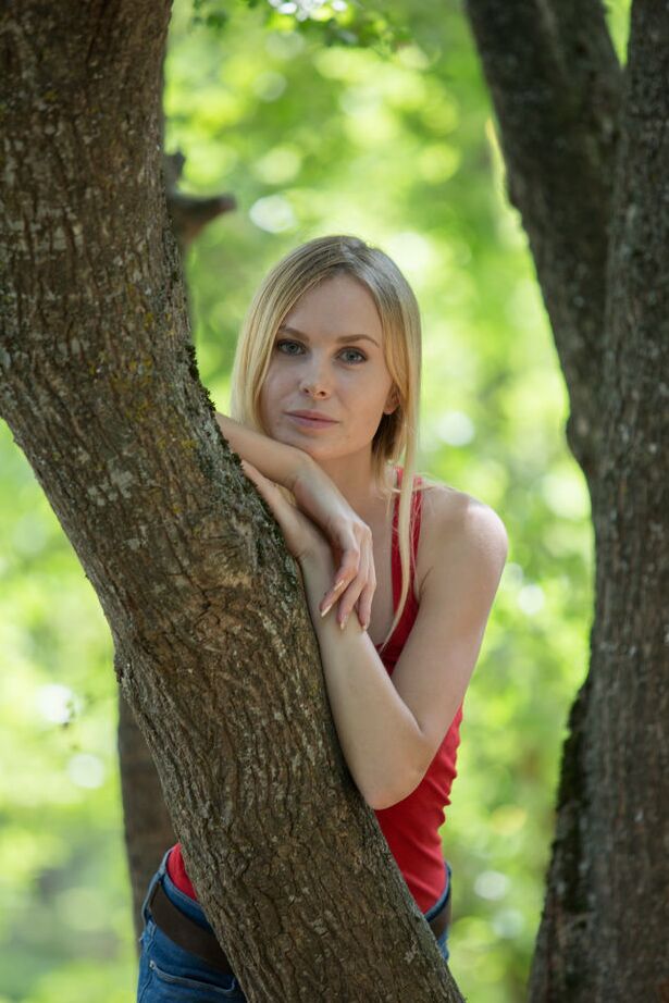 16P Young blonde Maria Rubio showcases her bald twat on a stump by a river
