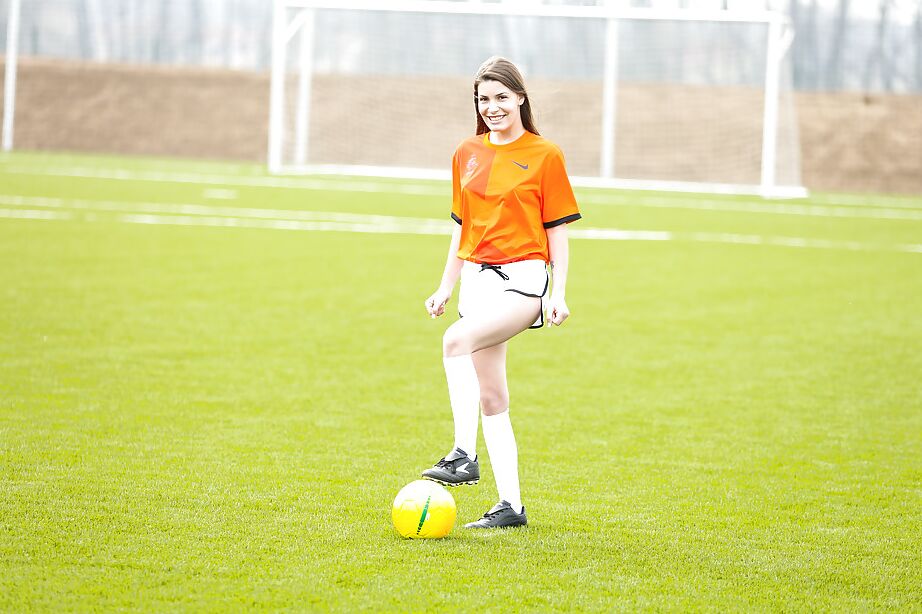 16P Lilly P is undressing her soccer uniform while on the field with a ball