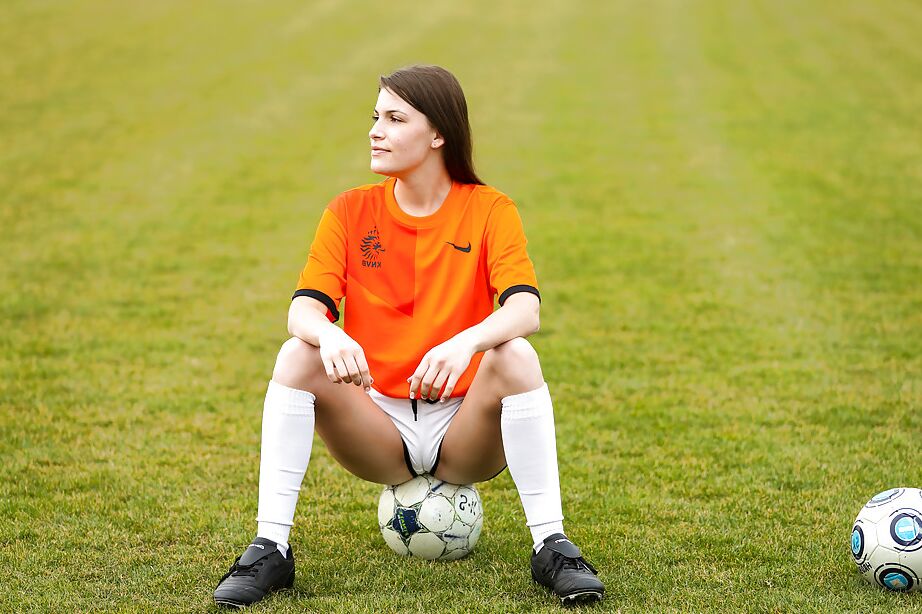 16P Lilly P is undressing her soccer uniform while on the field with a ball
