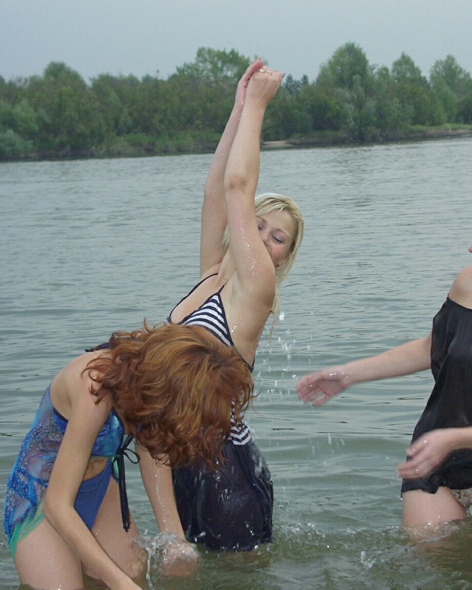 16P Teen girls partially remove wet clothing after wading into a river