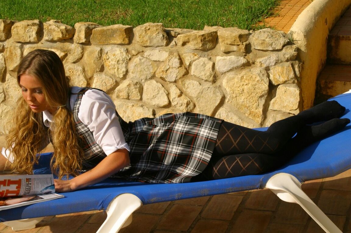 21P Long haired college babe with big tits Brooke W strips and sunbaths poolside