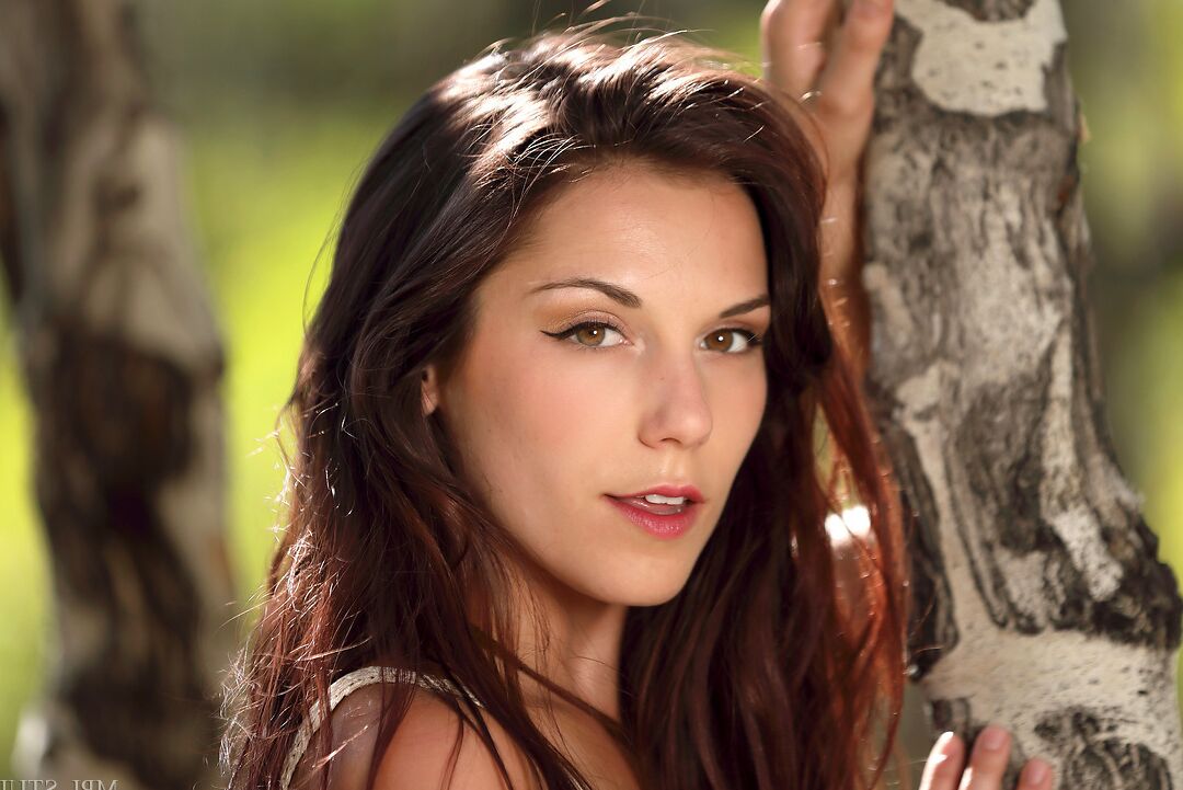 12P Pretty brunette gets totally naked on a fallen tree during solo action