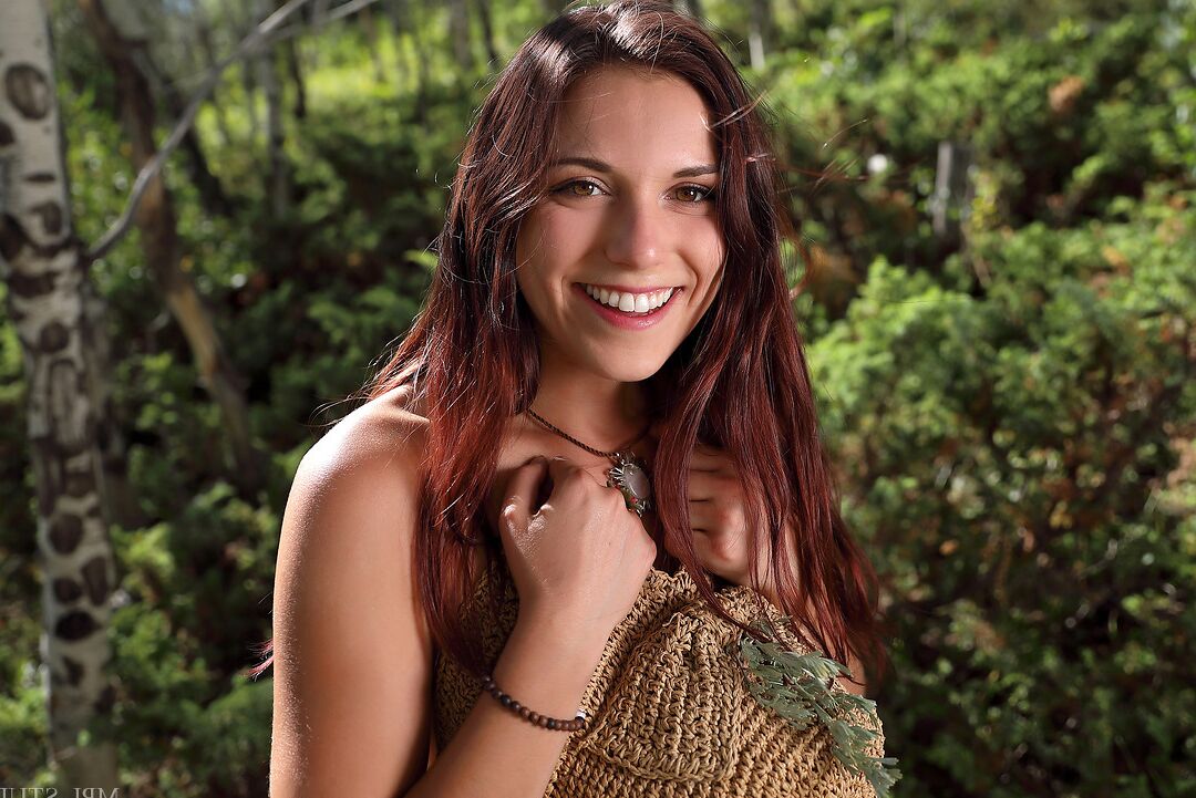 12P Pretty brunette gets totally naked on a fallen tree during solo action