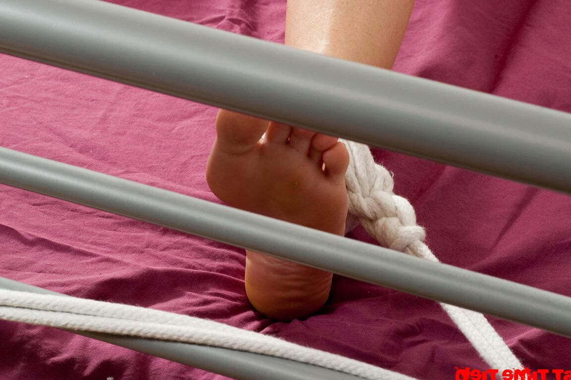 12P Nude brunette sports hard nipples while duct taped and tied with rope to a bed