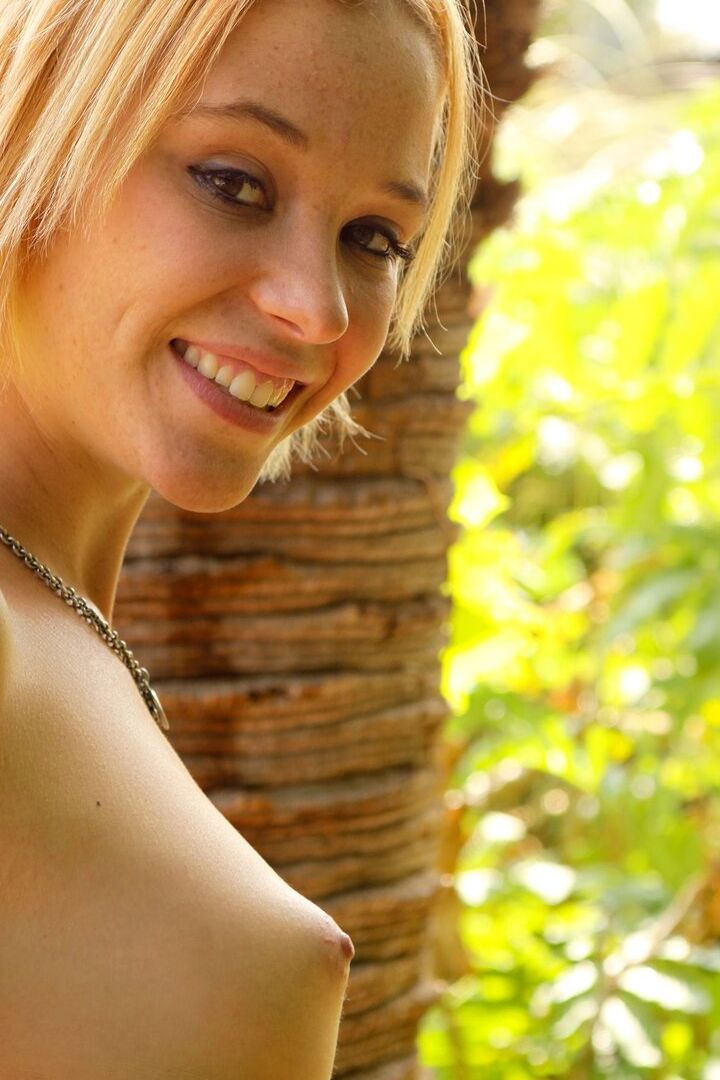 16P Blond amateur Charmed bares her sexy ass while getting naked under a palm tree