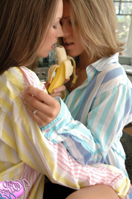 12P Teen lesbians Karen and Kate fool around with a banana in their pajamas