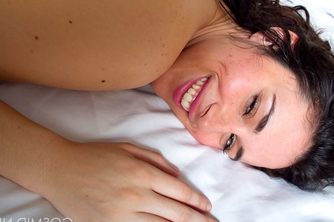 16P Smiling amateur Marianna flashing her nice tits and getting naked on the bed