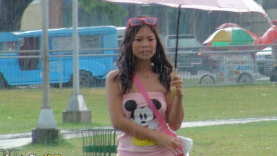 15P Asian amateur holds an umbrella in the rain before a hard POV fuck indoors