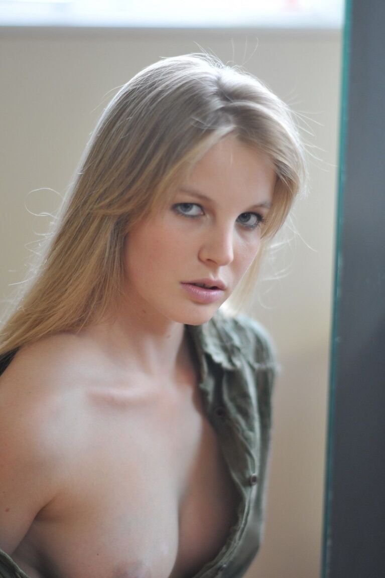 12P Barefoot blonde Rose displays her tight slit while sitting on a window sill