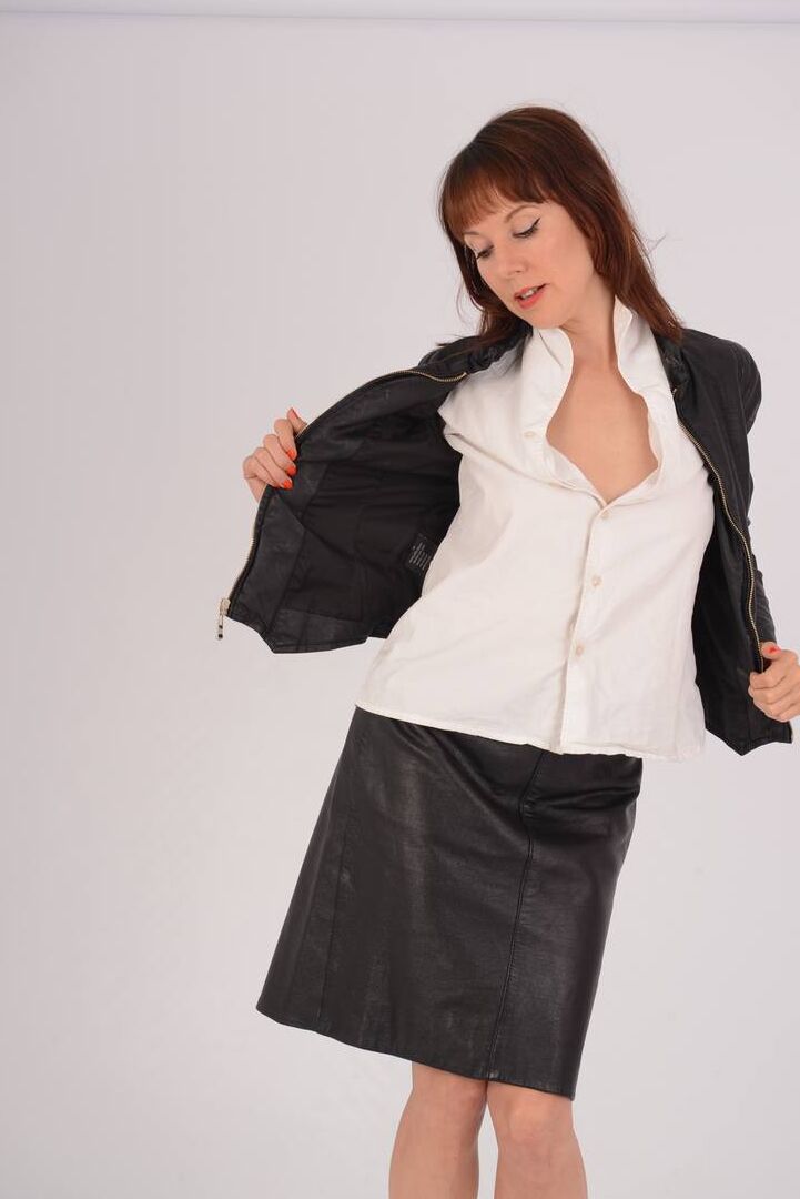 15P Hot redhead Cindy works a breast free of a white blouse and leather jacket