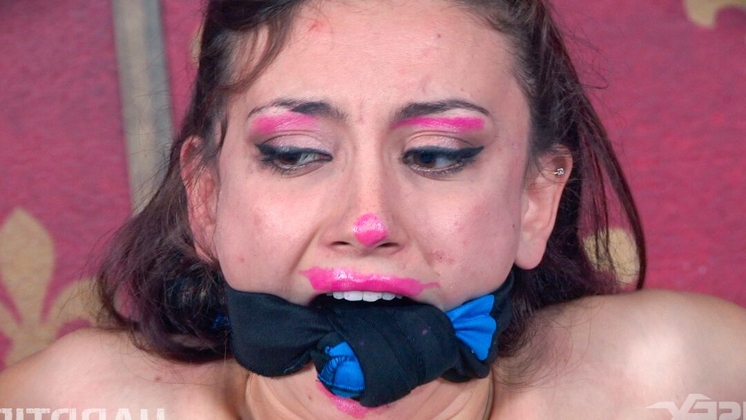 14P Ball gagged female Mandy Muse is restrained to a sofa with legs spread open