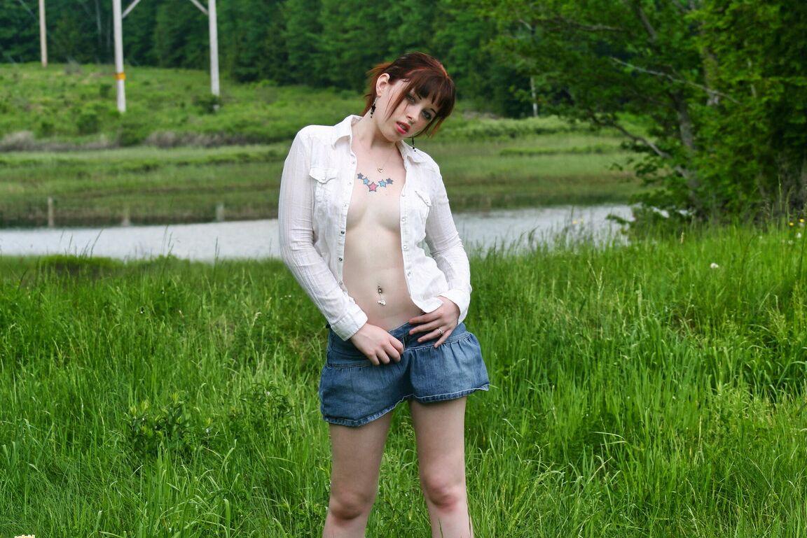 12P Amateur girl with red hair Barbie A exposes her tits while in a grassy field