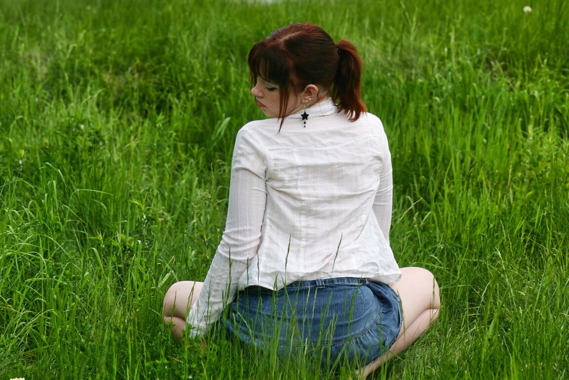 12P Amateur girl with red hair Barbie A exposes her tits while in a grassy field
