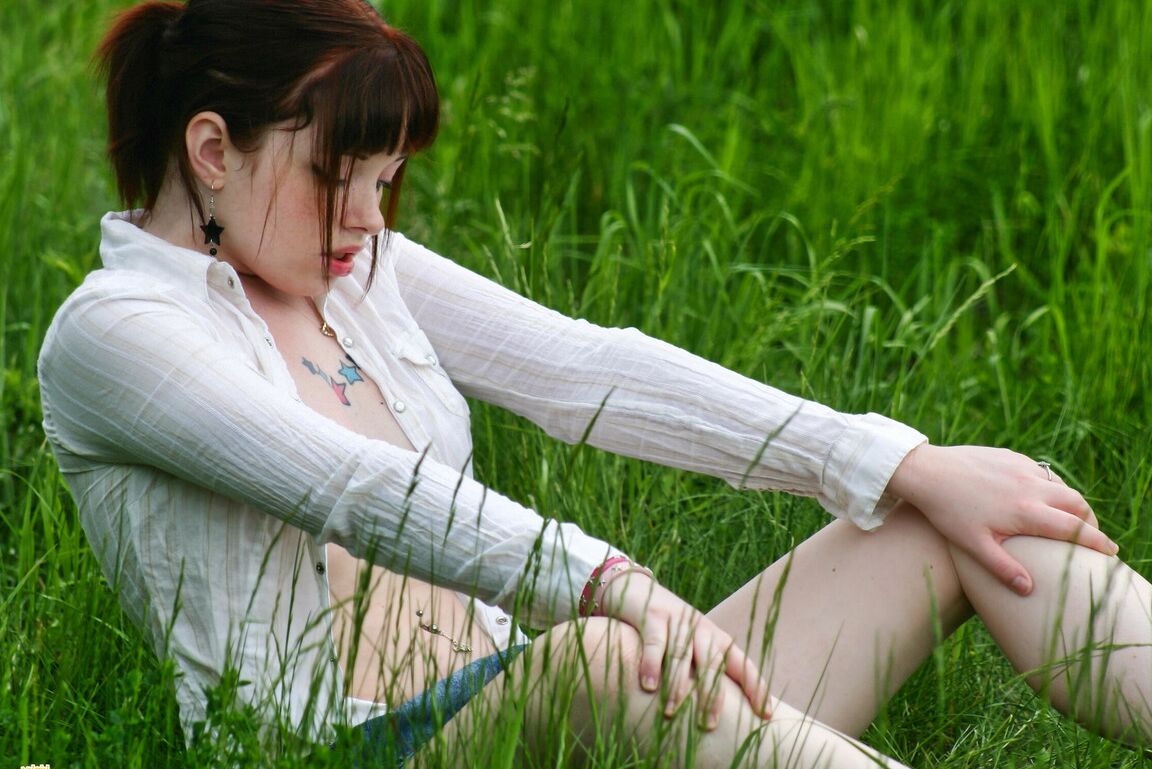 12P Amateur girl with red hair Barbie A exposes her tits while in a grassy field