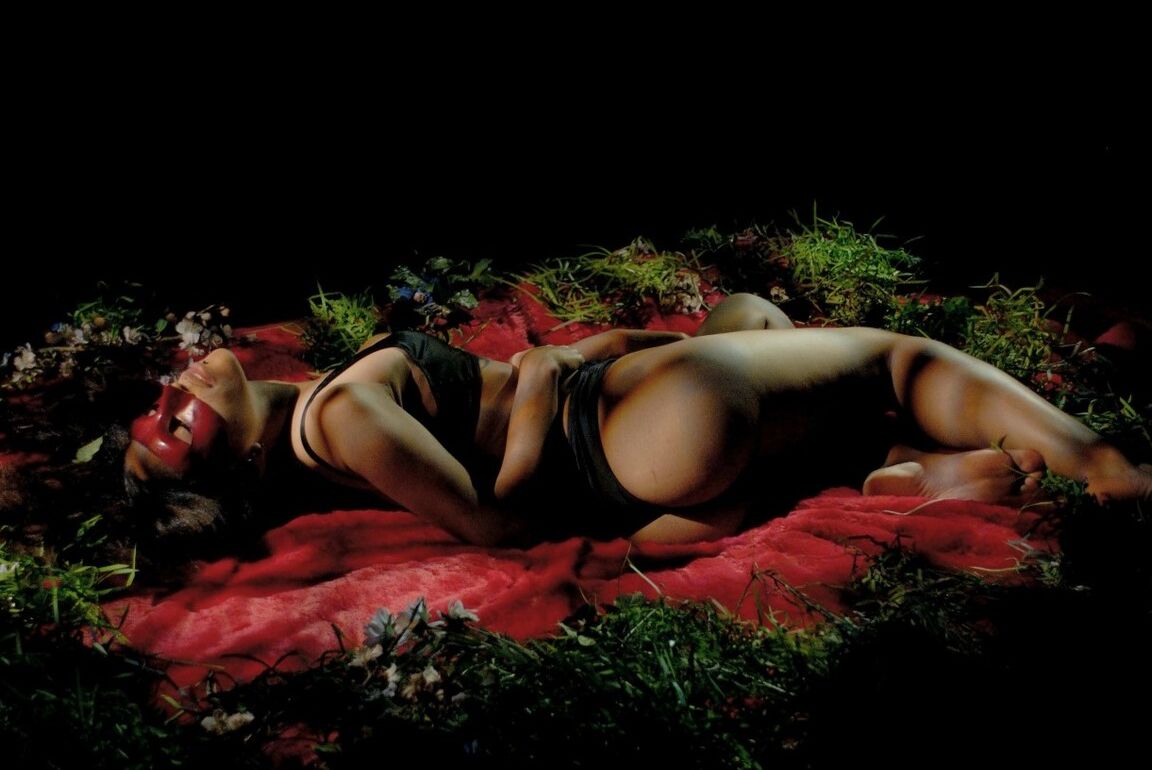 15P The beautiful girl sits on a red bed