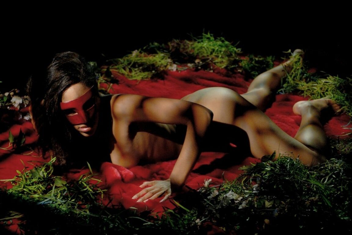 15P The beautiful girl sits on a red bed