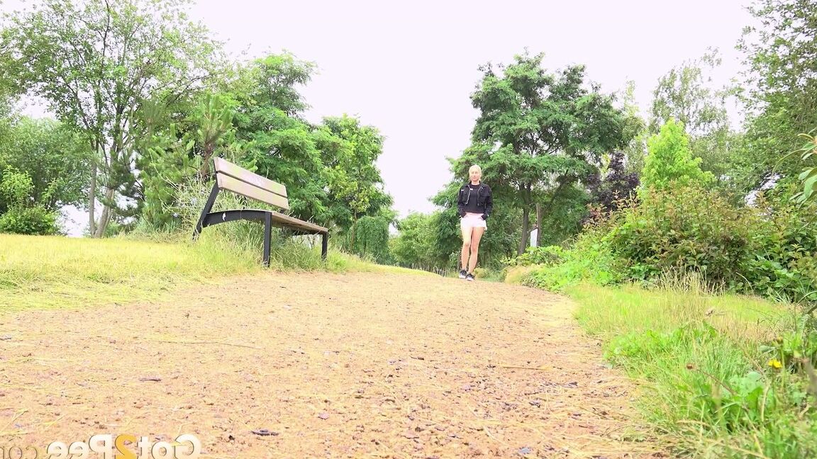 15P Blonde girl Vanessa Hell squats for a piss while taking a walk through a park