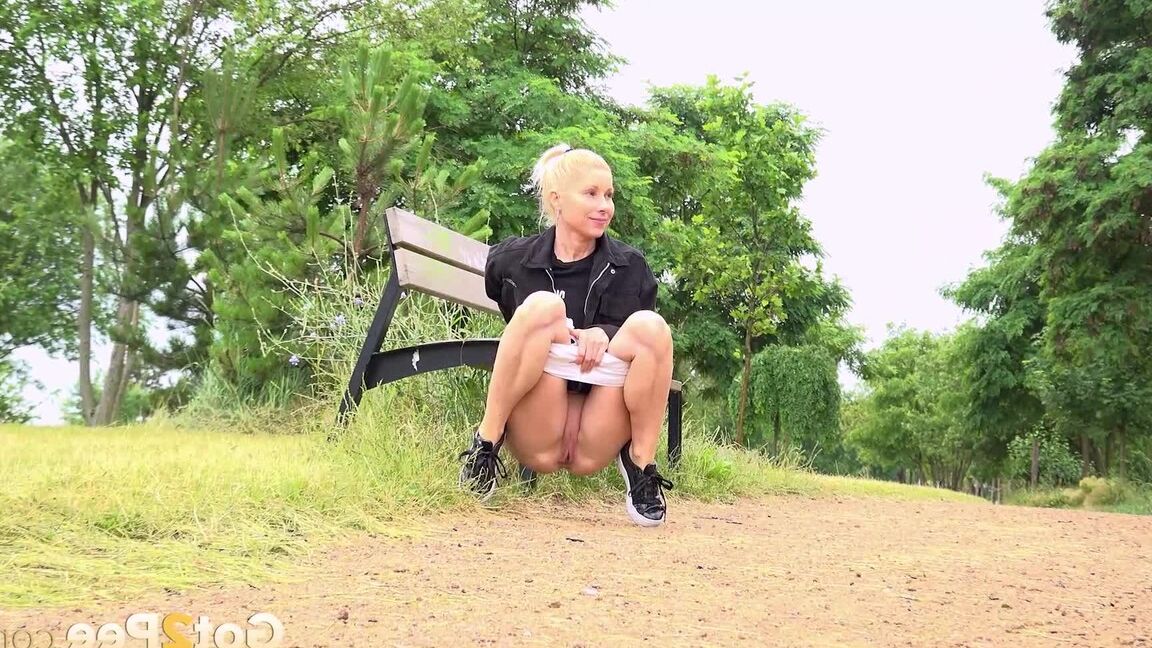 15P Blonde girl Vanessa Hell squats for a piss while taking a walk through a park