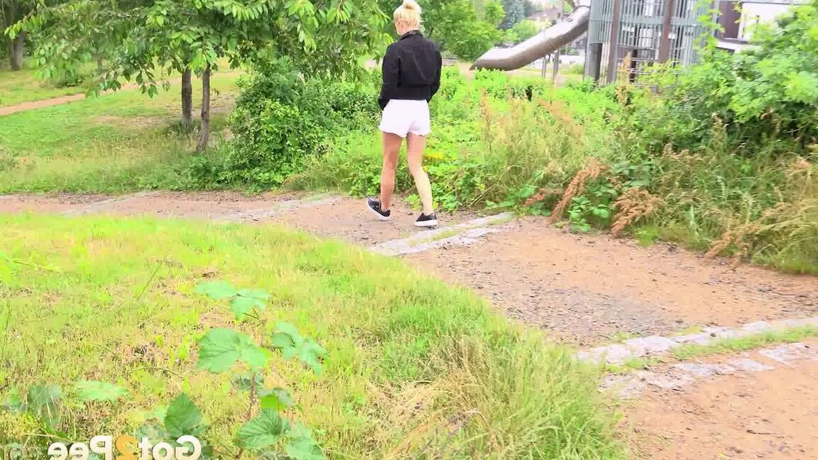 15P Blonde girl Vanessa Hell squats for a piss while taking a walk through a park