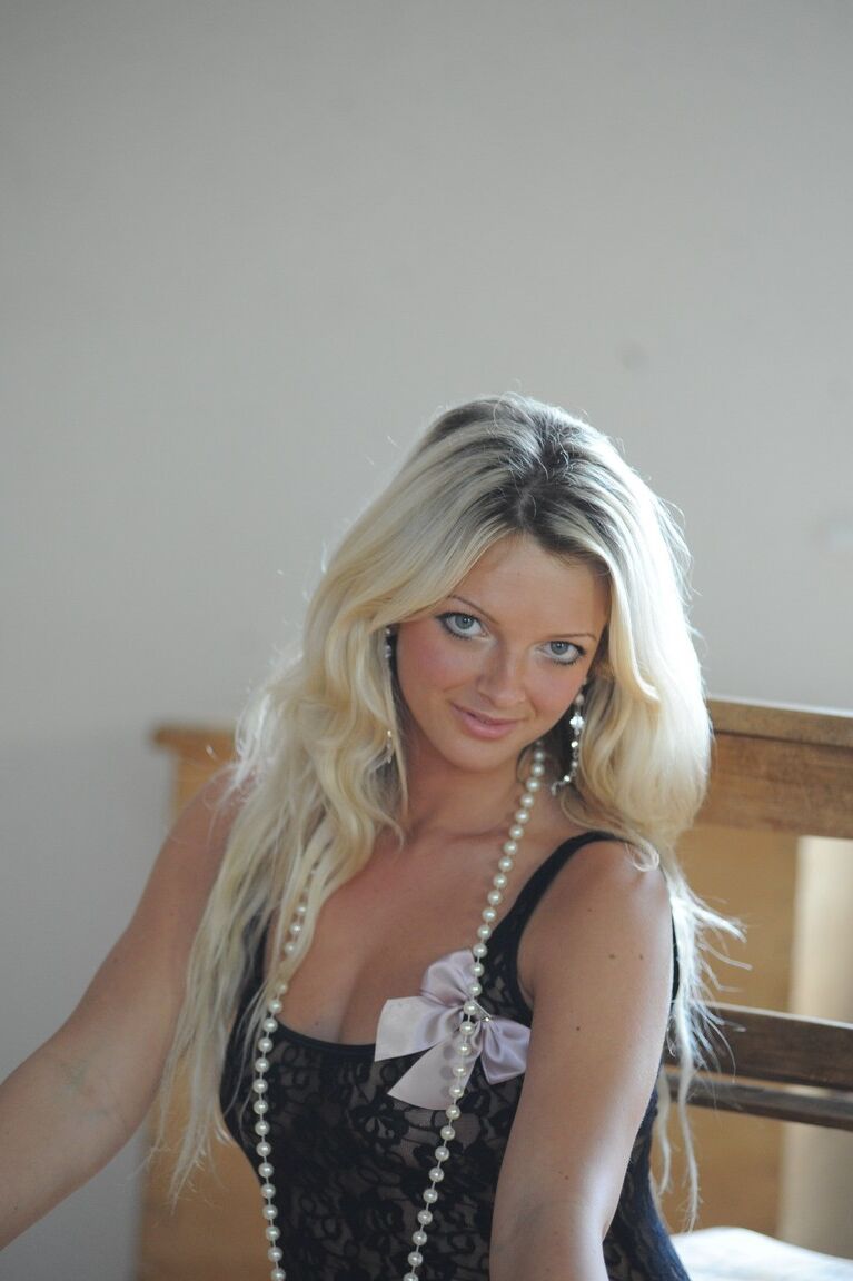 12P Blonde model Zuziana slip off a black bodysuit to pose nude in an attic room