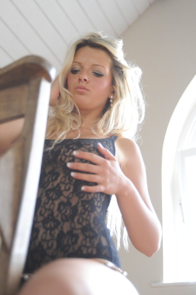 12P Blonde model Zuziana slip off a black bodysuit to pose nude in an attic room