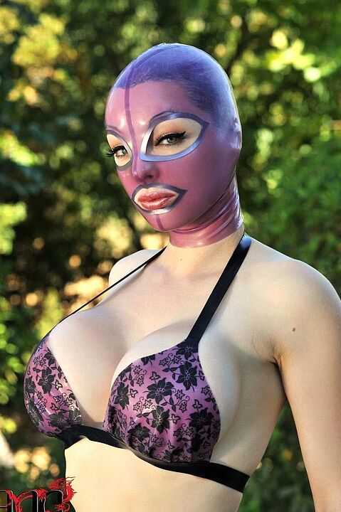 15P Latex Lucy frees her big tits and twat from lingerie in a rubber mask