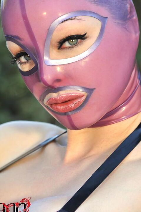 15P Latex Lucy frees her big tits and twat from lingerie in a rubber mask