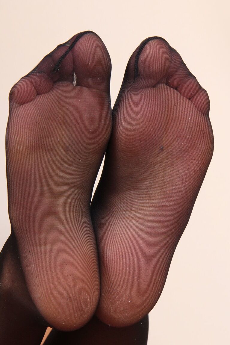 Gioia, modèle fétichiste des pieds de 12P, porte des bas noirs transparents pour afficher ses pieds sexy.