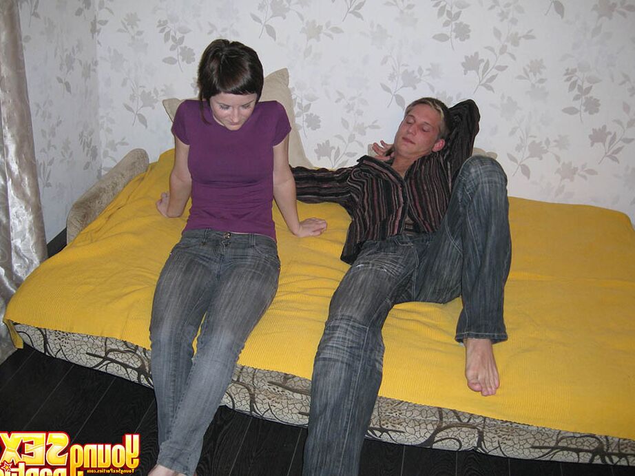 16P Teen girls and their guy friend remove jeans before having a 3some on a bed