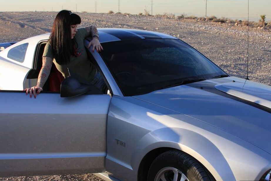 20P L'amatrice brune Susy Rocks expose ses jolis seins à l'intérieur d'une muscle car