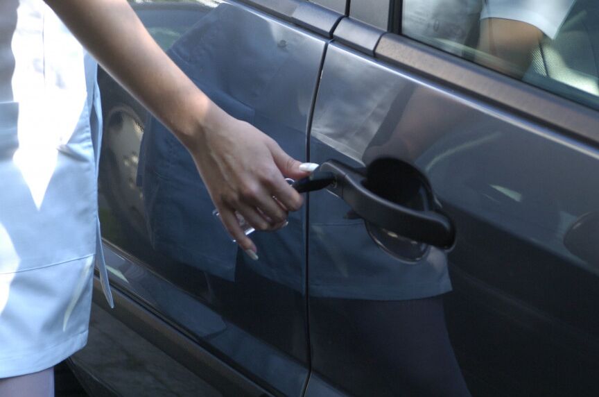 16P Clothed girl shows her stocking tops after getting behind the wheel of a car