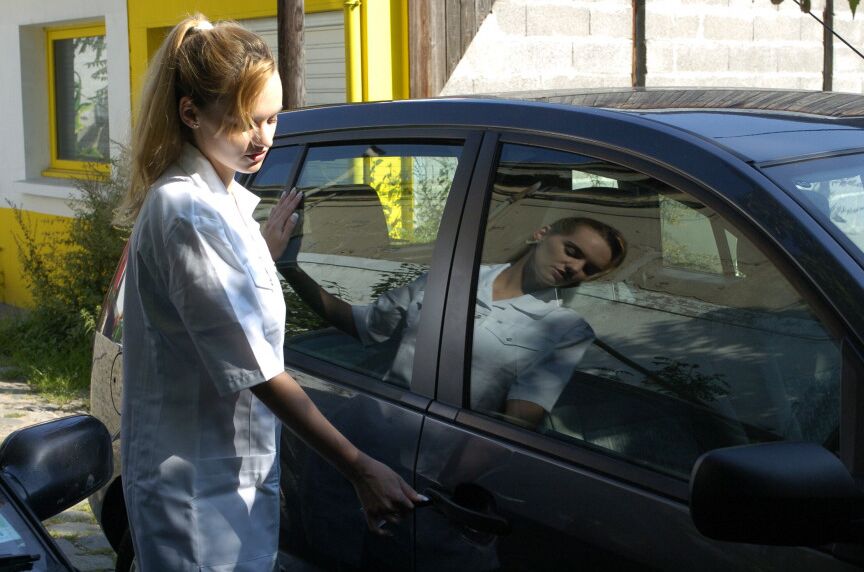 16P Clothed girl shows her stocking tops after getting behind the wheel of a car