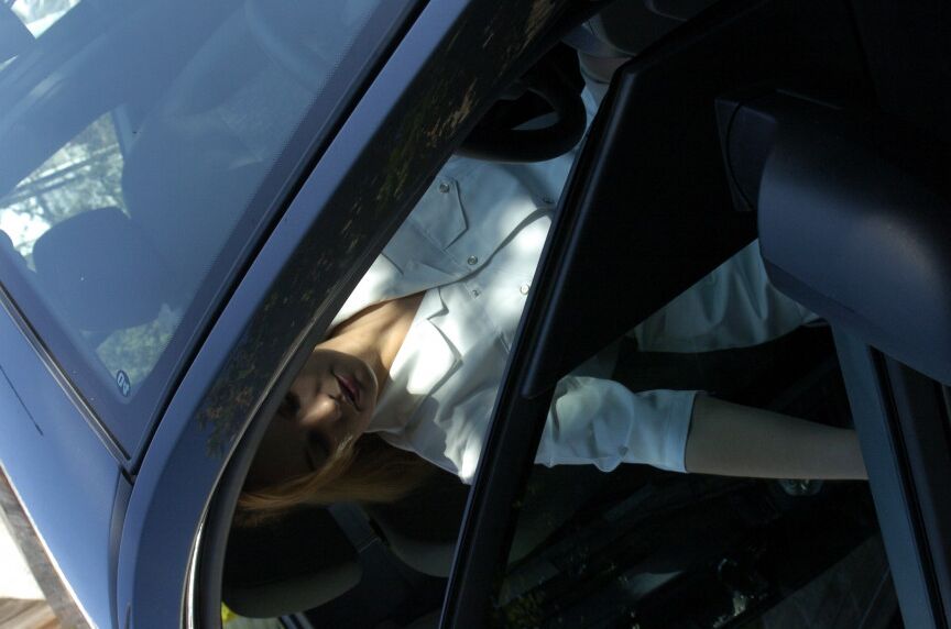 16P Clothed girl shows her stocking tops after getting behind the wheel of a car