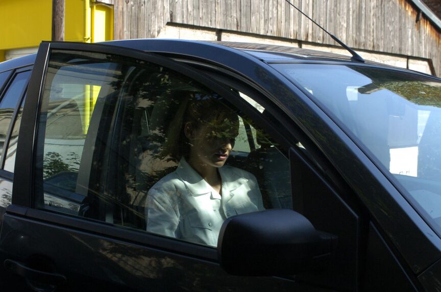 16P Clothed girl shows her stocking tops after getting behind the wheel of a car