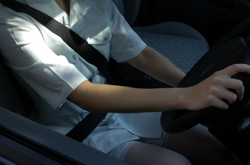 16P Clothed girl shows her stocking tops after getting behind the wheel of a car