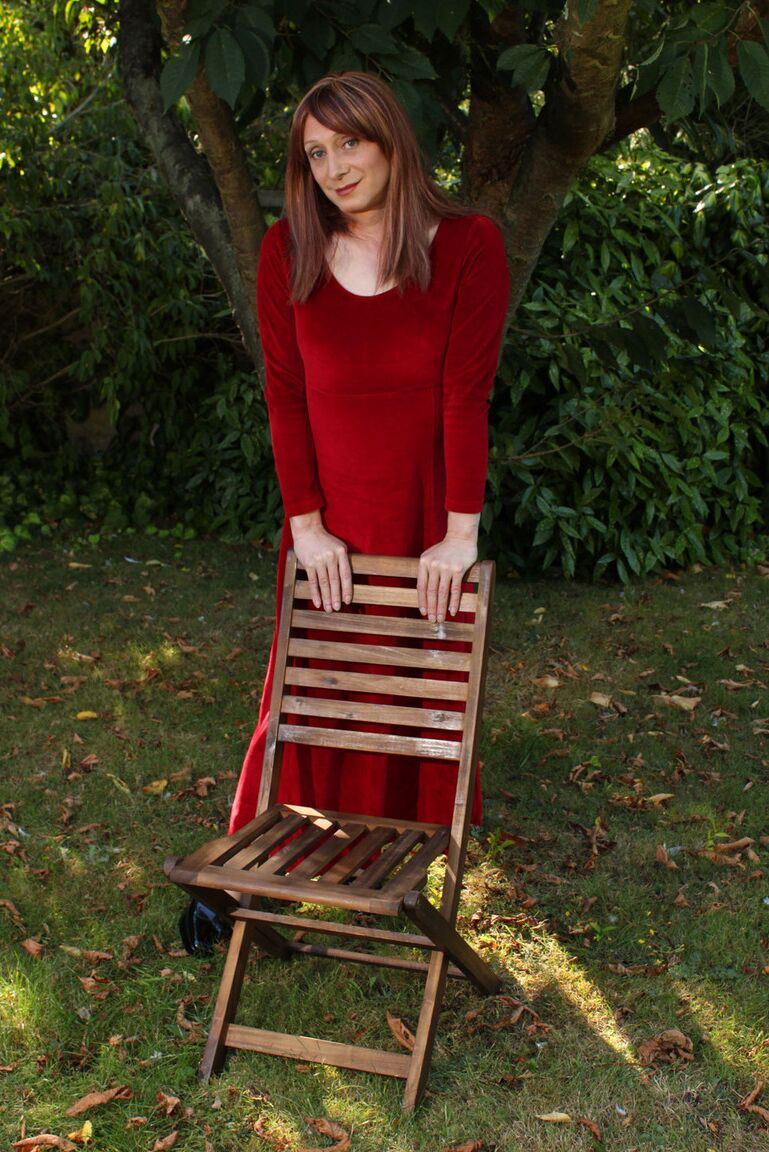 15P Lucimay posing outdoors in a gorgeous long red dress