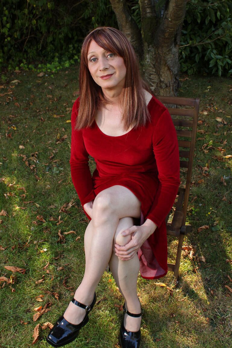 15P Lucimay posing outdoors in a gorgeous long red dress