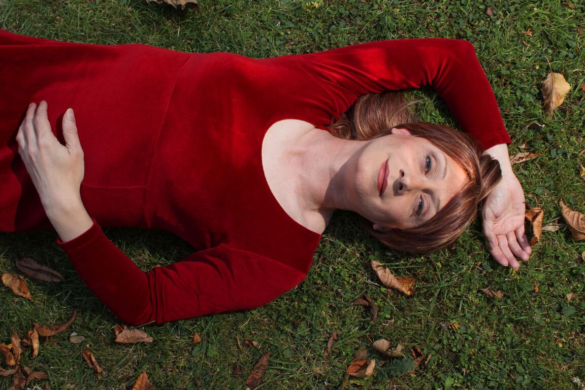 15P Lucimay posing outdoors in a gorgeous long red dress
