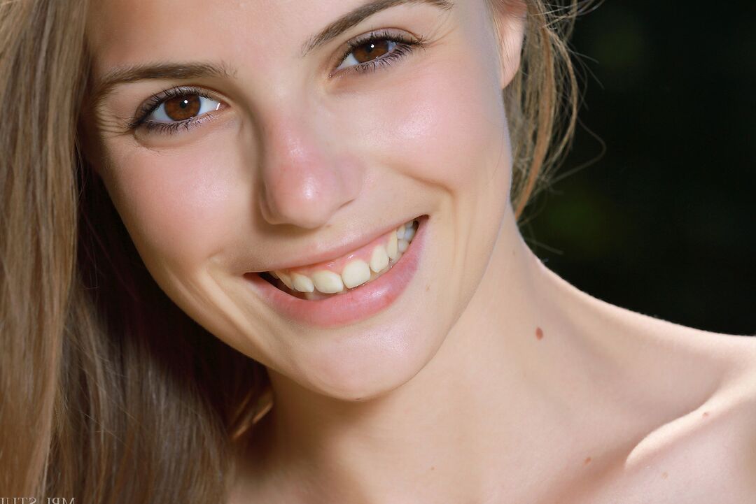 12P Chica con cara sonriente se arrodilla desnuda afuera para abrirse y mostrar su rosa