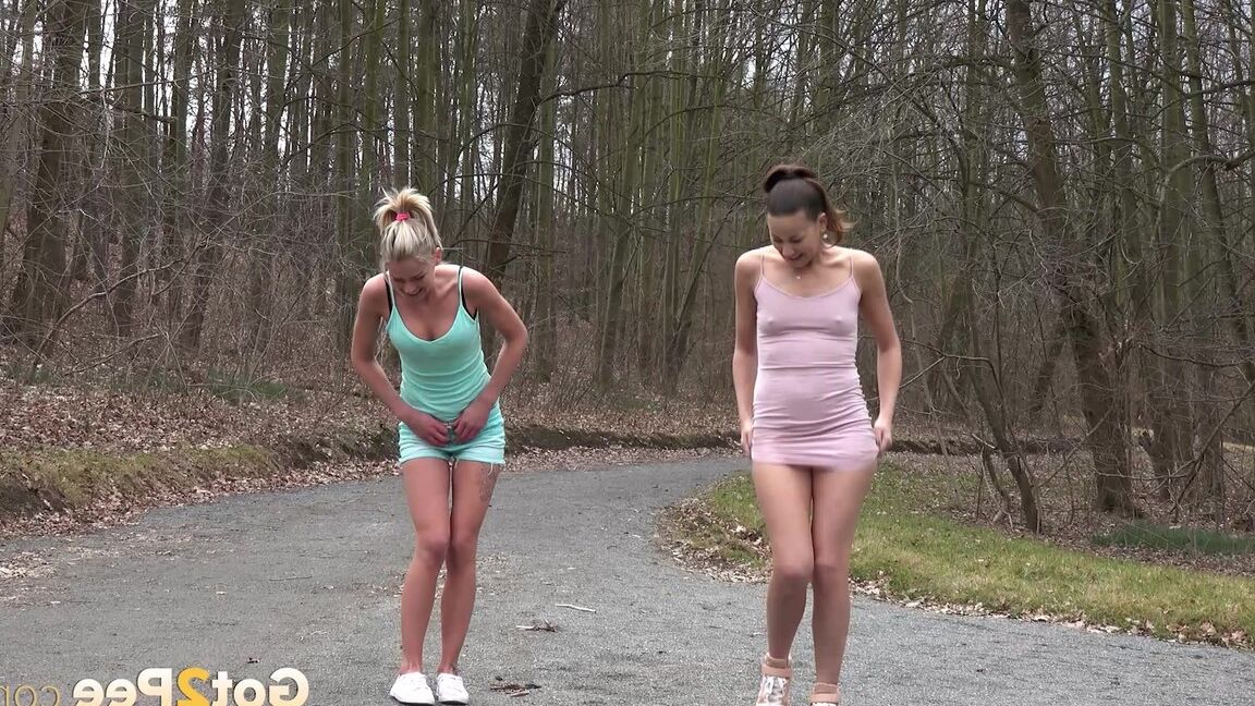 15P Desperate girls Yenna and Claudia Macc empty bladders on a gravel roadway