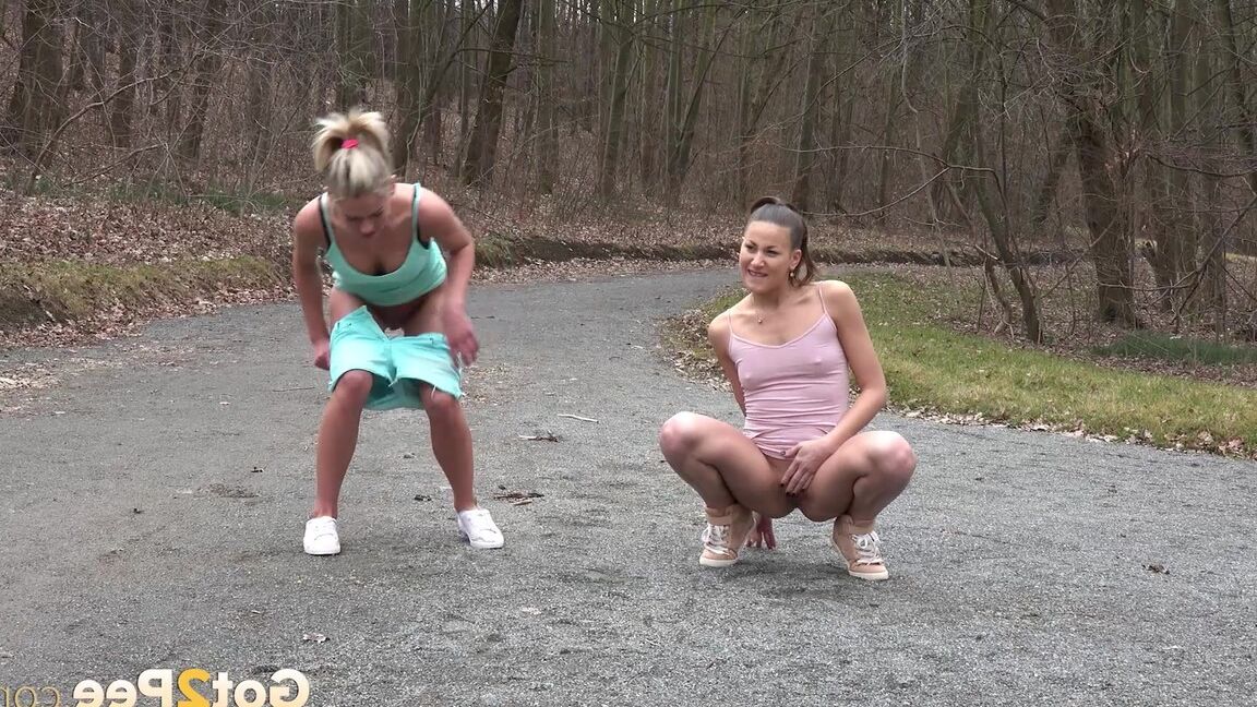 15P Desperate girls Yenna and Claudia Macc empty bladders on a gravel roadway