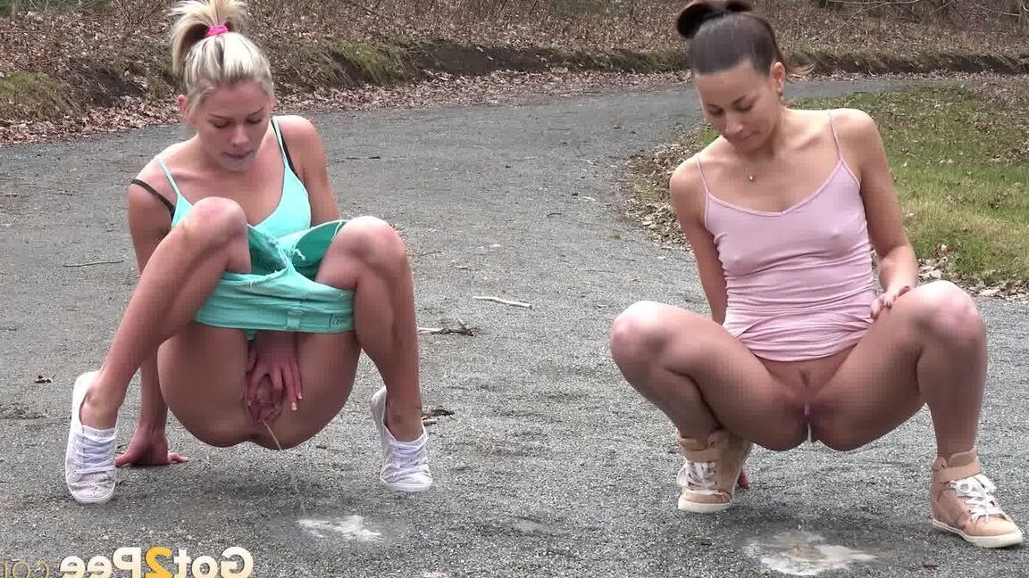 15P Desperate girls Yenna and Claudia Macc empty bladders on a gravel roadway
