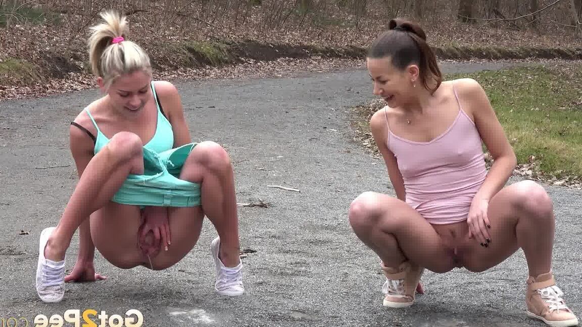 15P Desperate girls Yenna and Claudia Macc empty bladders on a gravel roadway