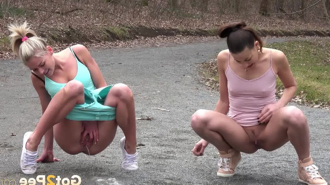 15P Desperate girls Yenna and Claudia Macc empty bladders on a gravel roadway