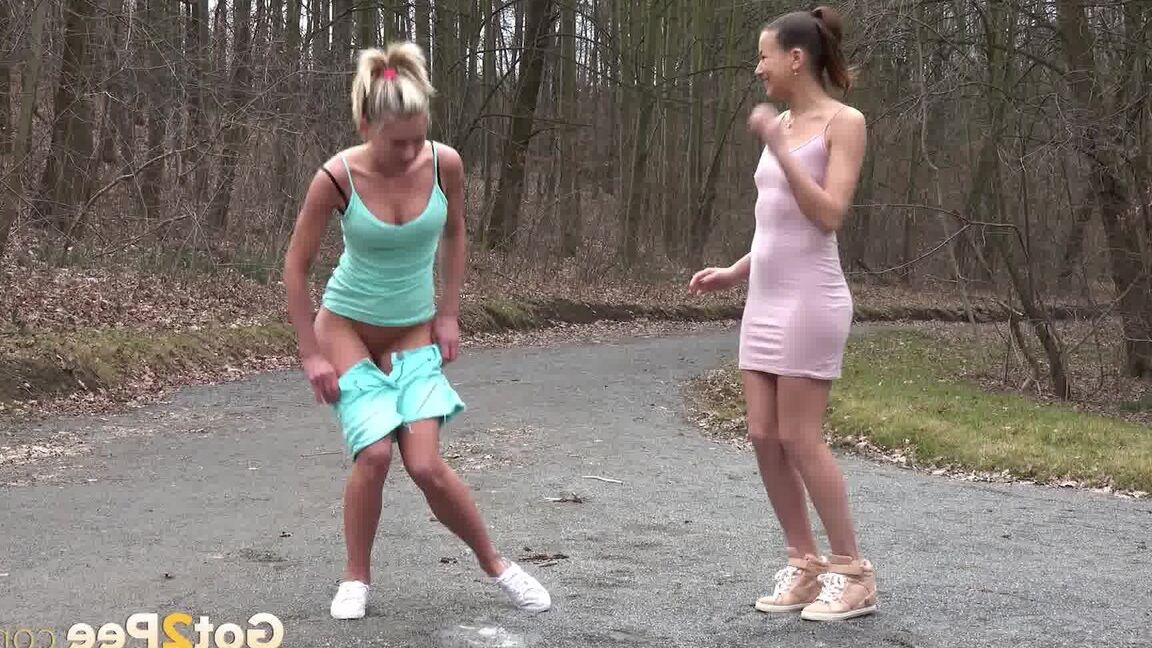 15P Desperate girls Yenna and Claudia Macc empty bladders on a gravel roadway
