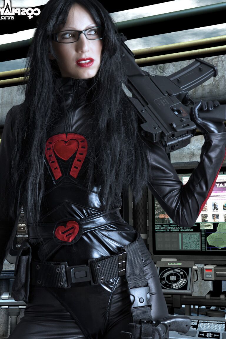 12P Brunette chick wields a rifle while removing cosplay clothing