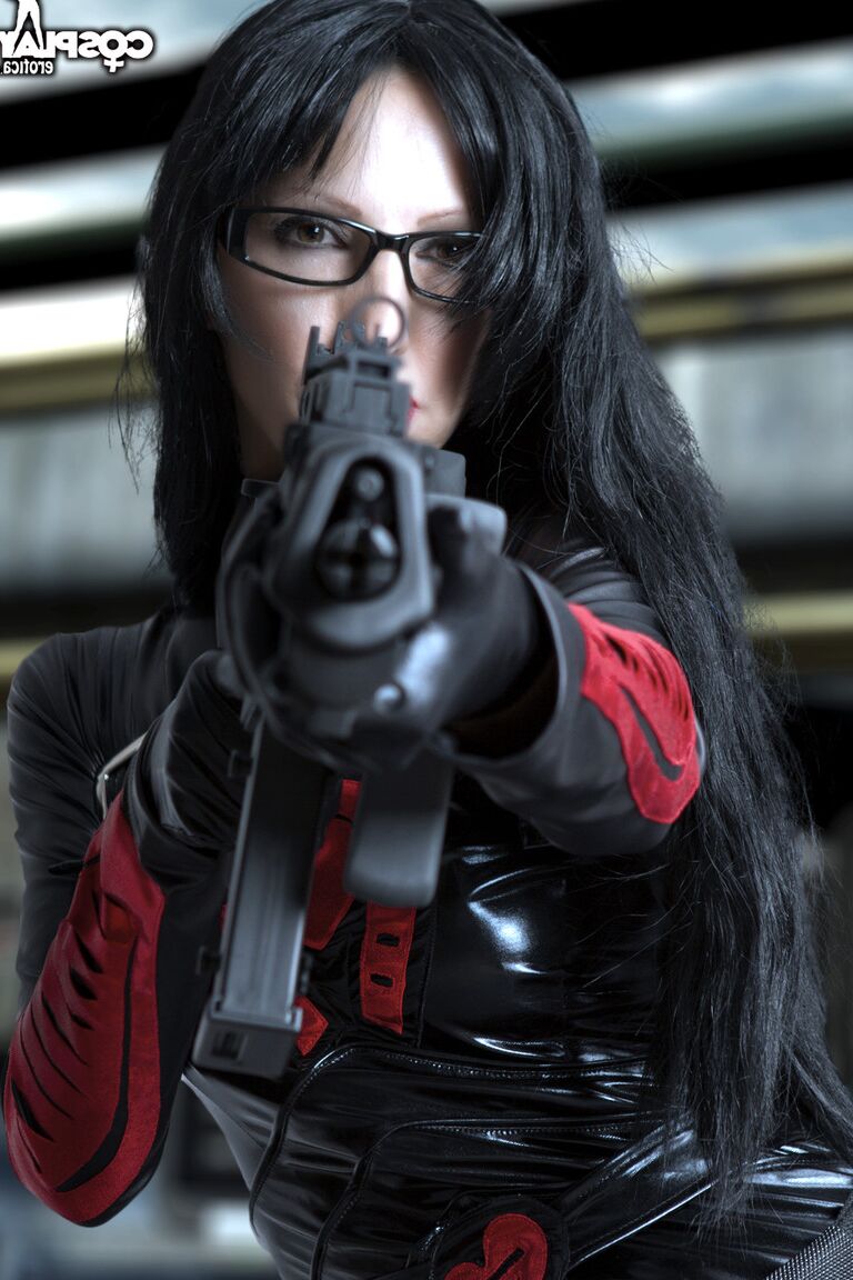 12P Brunette chick wields a rifle while removing cosplay clothing