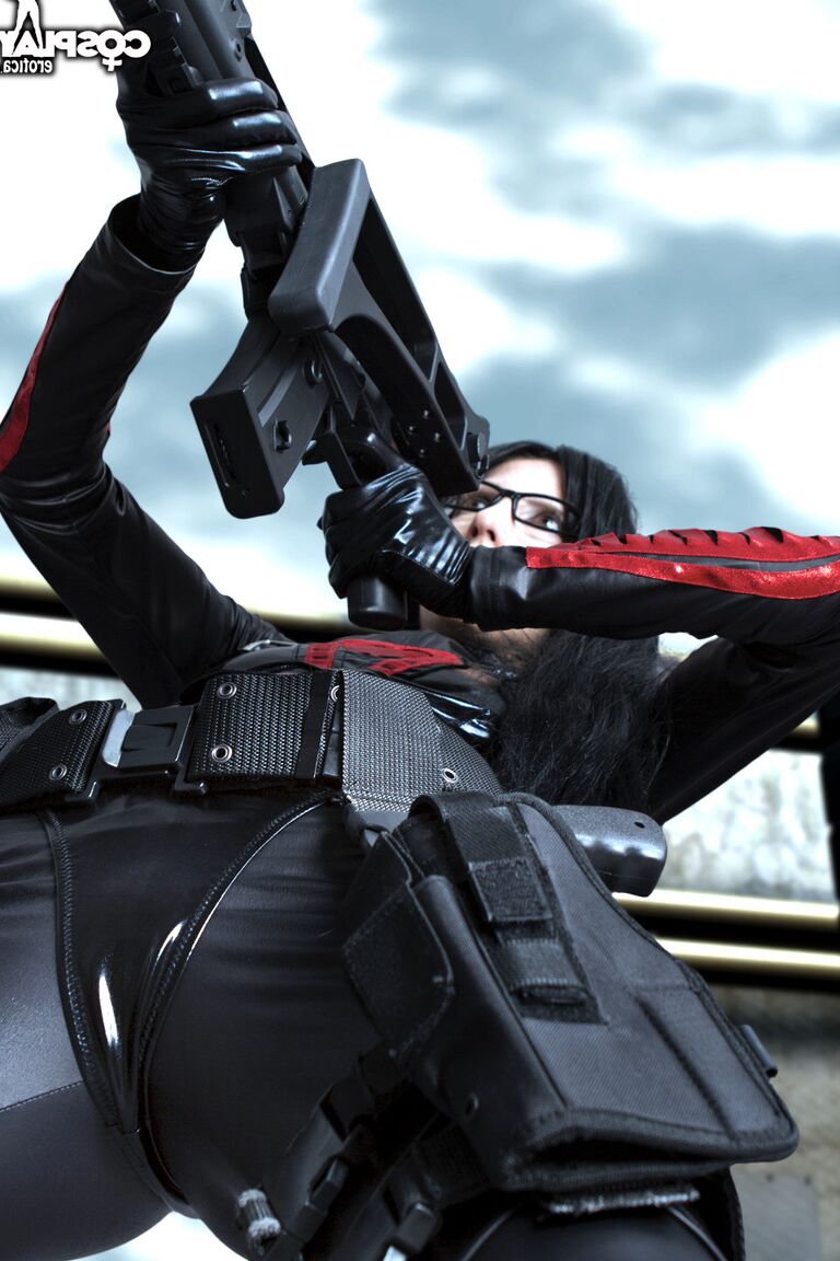 12P Brunette chick wields a rifle while removing cosplay clothing