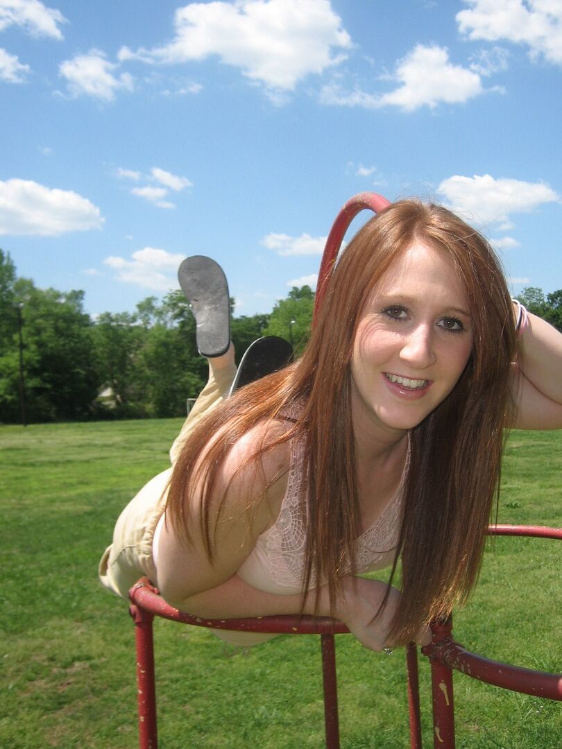 12P Cute ginger teen Ruby flashes her perky tits at the park while playing on the